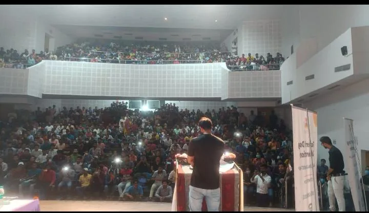 Bhunesh Sharma addressing an audience in an auditorium
