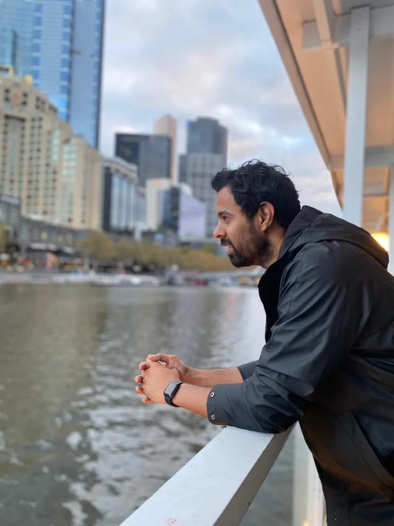 Bhunesh Sharma looking across a city waterfront
