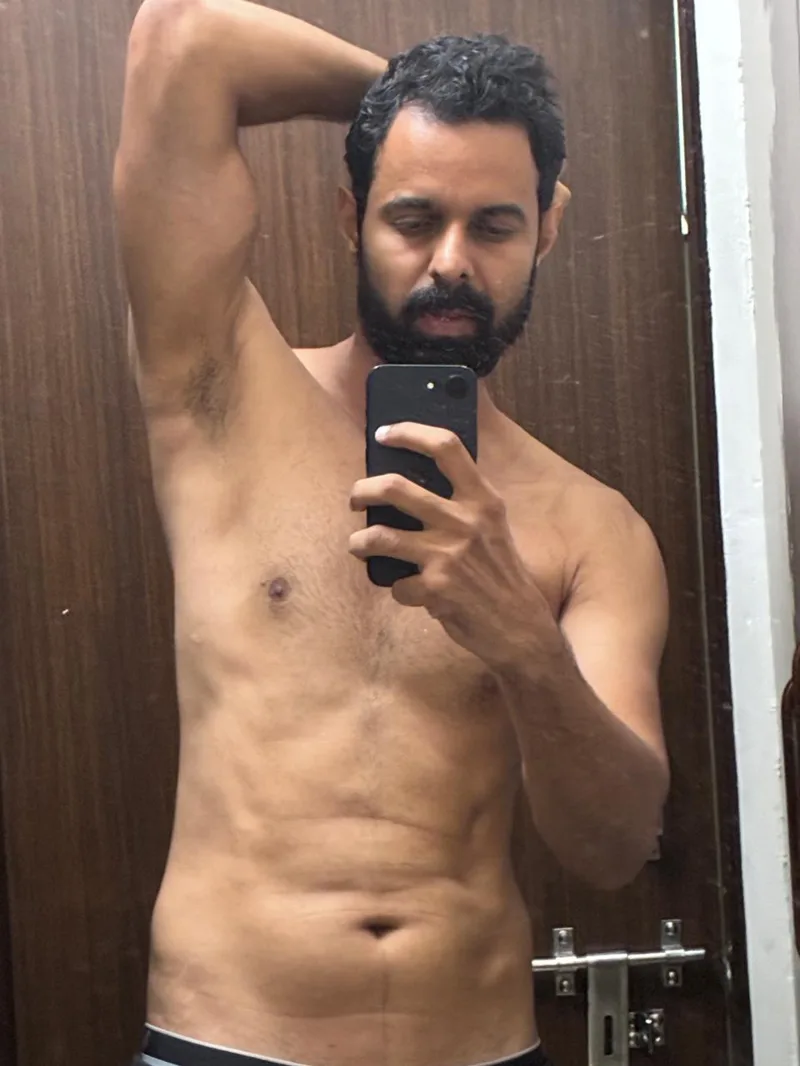 Bhunesh Sharma posing with one arm raised in a mirror selfie