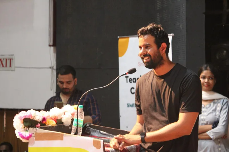 Bhunesh Sharma speaking at a podium during an event